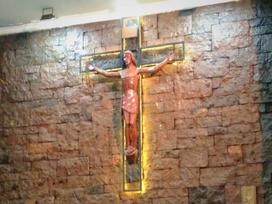 Interior of a stone wall room with stained glass window